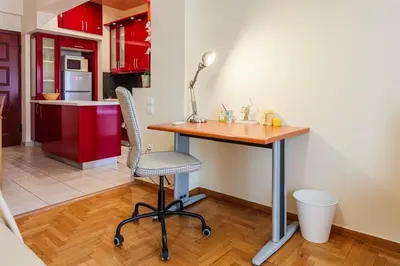 a kitchen with a table and a chair in a room at Athens Strawberry Hideaway - City Cozy Gem in Athens