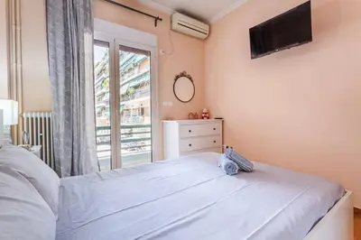 a bedroom with a bed and a large window at Athens Strawberry Hideaway - City Cozy Gem in Athens