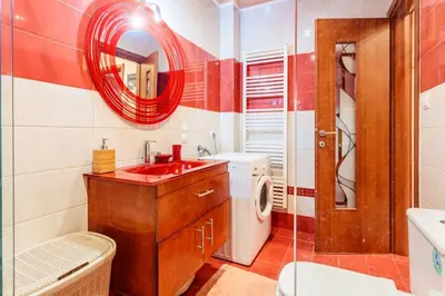 a bathroom with a sink and a washing machine at Athens Strawberry Hideaway - City Cozy Gem in Athens