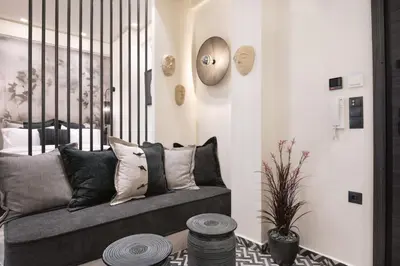 a living room with a gray couch with pillows at Adrianou at Heart of Plaka in Athens