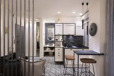 a kitchen with white cabinets and a table and stools at Adrianou at Heart of Plaka in Athens