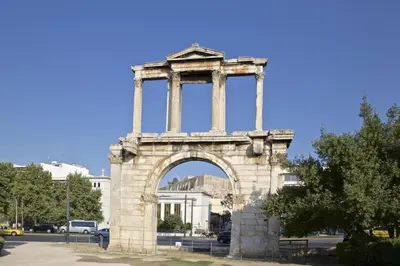 a building with an arch in front of a street at Adrianou at Heart of Plaka in Athens