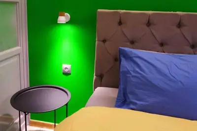 a green bedroom with a bed and a green wall at CASA VERDE di Giorgio 10 mins walk from Piraeus port in Piraeus