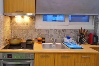 a kitchen with a sink and a stove at CASA VERDE di Giorgio 10 mins walk from Piraeus port in Piraeus