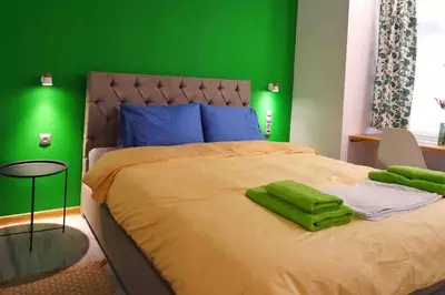 a green bedroom with a bed with a green wall at CASA VERDE di Giorgio 10 mins walk from Piraeus port in Piraeus