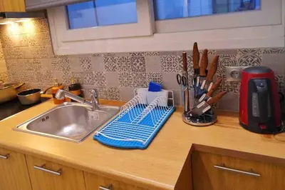 a kitchen counter with a sink and a mixer at CASA VERDE di Giorgio 10 mins walk from Piraeus port in Piraeus