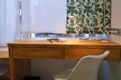 a wooden desk with a chair next to a window at CASA VERDE di Giorgio 10 mins walk from Piraeus port in Piraeus