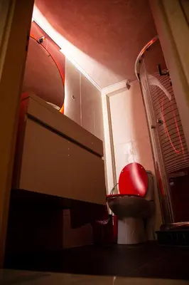 a bathroom with a toilet and a computer monitor at Athens Nautical Flat in Piraeus