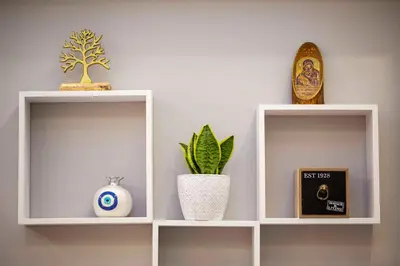 two white shelves with vases and a plant on them at Athens Nautical Flat in Piraeus