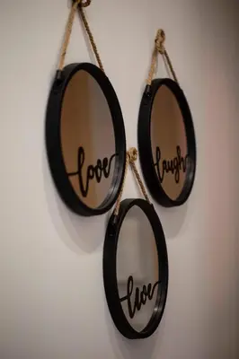 two mirrors hanging on a wall with the words love and oxygen at Athens Nautical Flat in Piraeus