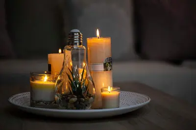 a plate with candles and a bottle on a table at Athens Nautical Flat in Piraeus