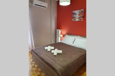 a bedroom with a bed with two towels on it at Greek hospitality in a modern apartment in Athens