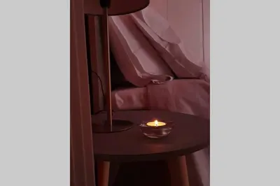 a small black table with a candle on it at Greek hospitality in a modern apartment in Athens