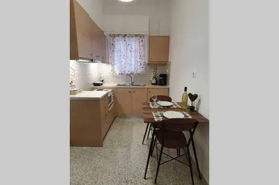 a kitchen with a table and chairs in it at Greek hospitality in a modern apartment in Athens