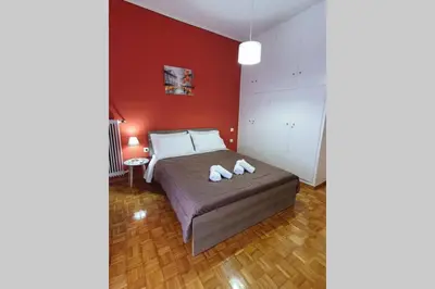 a bedroom with a bed with two towels on it at Greek hospitality in a modern apartment in Athens