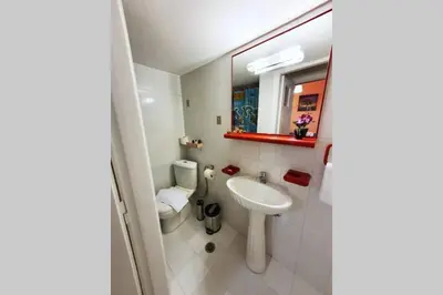 a white bathroom with a sink and a toilet at Greek hospitality in a modern apartment in Athens
