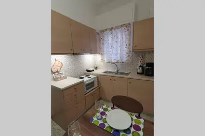 a small kitchen with a table and a sink at Greek hospitality in a modern apartment in Athens