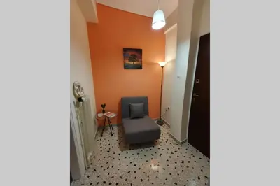 a room with a blue chair and a lamp at Greek hospitality in a modern apartment in Athens