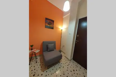 a room with a blue chair in a room at Greek hospitality in a modern apartment in Athens