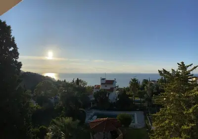 a view of a house with the ocean in the background at VILLA ELENI in Anavissos
