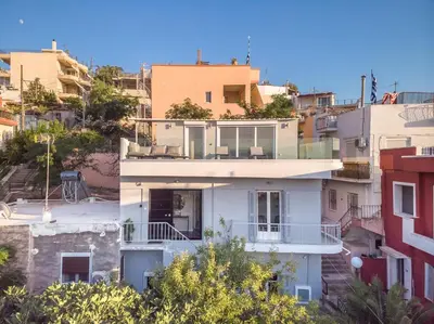a house in the middle of some buildings at ☆Acropolis View Villa☆Free Cancellation☆Rooftop Terrace☆ in Athens