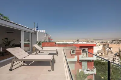 a balcony with two lounge chairs on a building at ☆Acropolis View Villa☆Free Cancellation☆Rooftop Terrace☆ in Athens