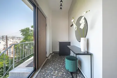 a balcony with a table and a vase of flowers at ☆Acropolis View Villa☆Free Cancellation☆Rooftop Terrace☆ in Athens