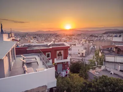 a view of a city at sunset at ☆Acropolis View Villa☆Free Cancellation☆Rooftop Terrace☆ in Athens