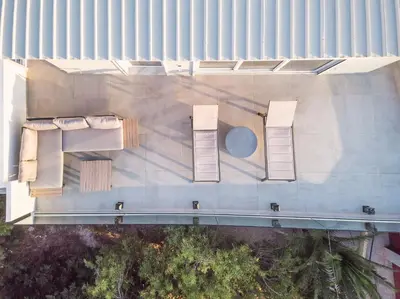 an overhead view of a building with chairs at ☆Acropolis View Villa☆Free Cancellation☆Rooftop Terrace☆ in Athens