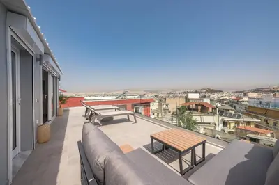 a balcony with benches and tables on a building at ☆Acropolis View Villa☆Free Cancellation☆Rooftop Terrace☆ in Athens