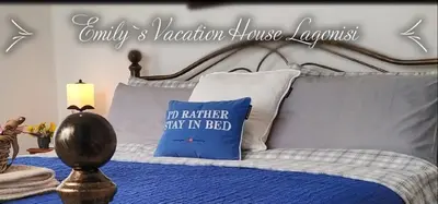 a bed with a blue comforter and a blue pillow at House Sleeps 4 with Pets in Kalívia Thorikoú
