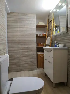 a bathroom with a toilet and a sink at House Sleeps 4 with Pets in Kalívia Thorikoú