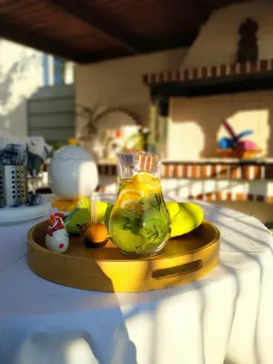 a jar of lemonade on a wooden tray on a table at House Sleeps 4 with Pets in Kalívia Thorikoú