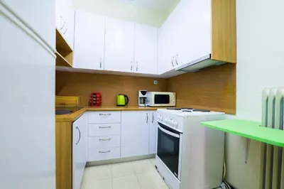a kitchen with white cabinets and a white oven at Athens Colors Suite in Athens