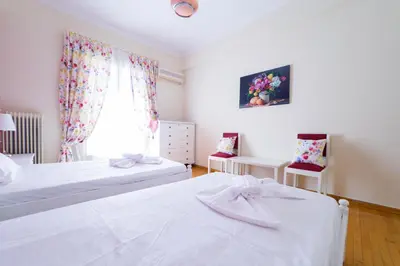 a bedroom with two beds and a window at Athens Colors Suite in Athens