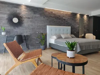 a bedroom with a bed and a brick wall at Sunny lovely apartment 60 meters from the metro in Athens
