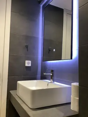 a bathroom with a white sink and a mirror at Sunny lovely apartment 60 meters from the metro in Athens