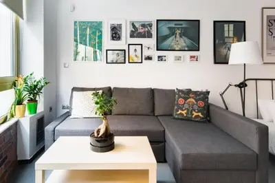 a living room with a couch and a table at Explore a New Arts District from a Hip Studio Flat in Athens