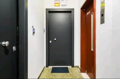 a black door with a mat in a hallway at Explore a New Arts District from a Hip Studio Flat in Athens