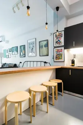 a kitchen with two tables and two stools at Explore a New Arts District from a Hip Studio Flat in Athens