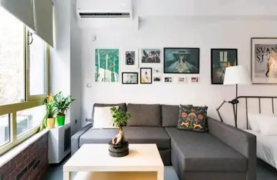 a living room with a couch and a table at Explore a New Arts District from a Hip Studio Flat in Athens