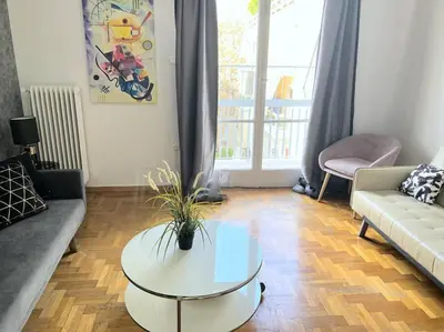 a living room with a couch and a table at Eχquisite apt in Acropolis-plaka/vaccinatedHost in Athens