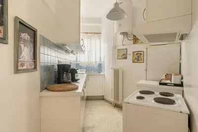 a white kitchen with a stove and a refrigerator at Eχquisite apt in Acropolis-plaka/vaccinatedHost in Athens