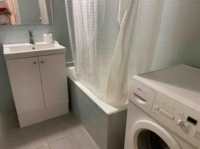 a bathroom with a washing machine and a sink at Downtown Athens-Plaka Skoufou Apt/VaccinatedHost in Athens
