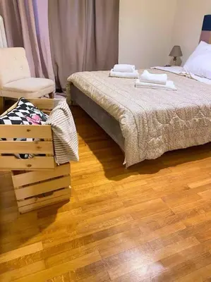 a bedroom with two beds and a wooden floor at Downtown Athens-Plaka Skoufou Apt/VaccinatedHost in Athens