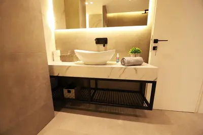 a bathroom with a sink and a mirror at K58 Luxury Apartment Monastiraki Metro Station Acropolis Jacuzzi by GK Properties in Athens