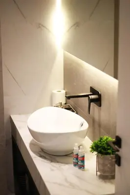 a bathroom with a white bowl sink on a counter at K58 Luxury Apartment Monastiraki Metro Station Acropolis Jacuzzi by GK Properties in Athens