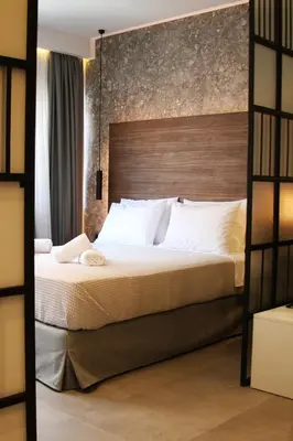 a bedroom with a large bed with a wooden headboard at K58 Luxury Apartment Monastiraki Metro Station Acropolis Jacuzzi by GK Properties in Athens