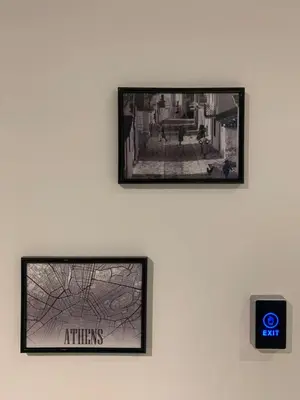 two framed pictures on a wall with a clock on a wall at K58 Luxury Apartment Monastiraki Metro Station Acropolis Jacuzzi by GK Properties in Athens