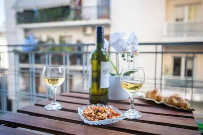 a bottle of wine and two glasses on a table at Blue Ark Acropolis Light in Athens